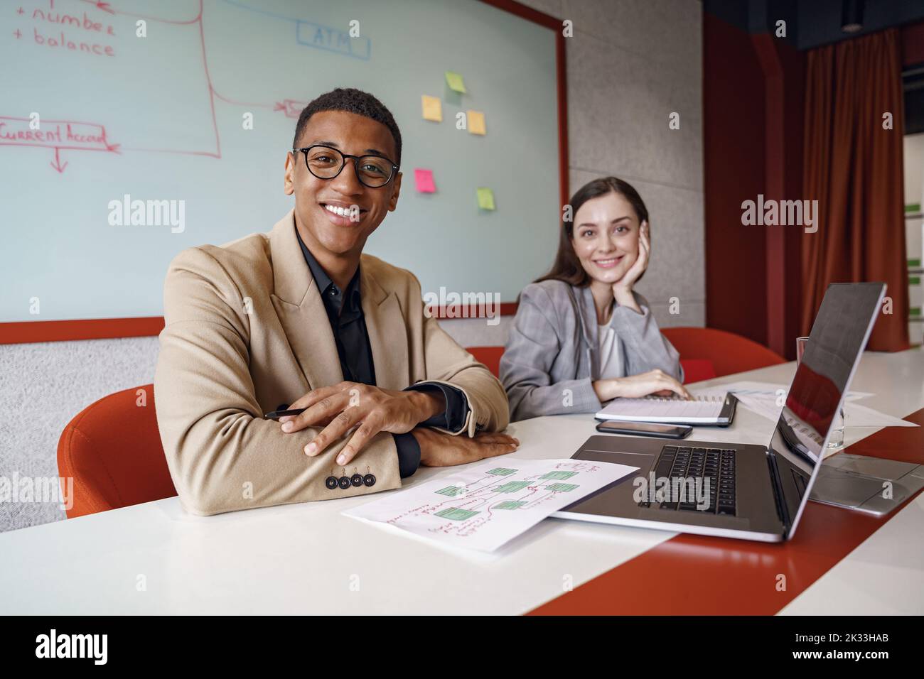 Smiling coworkers cooperating and working together at coworking space, teamwork concept Stock Photo