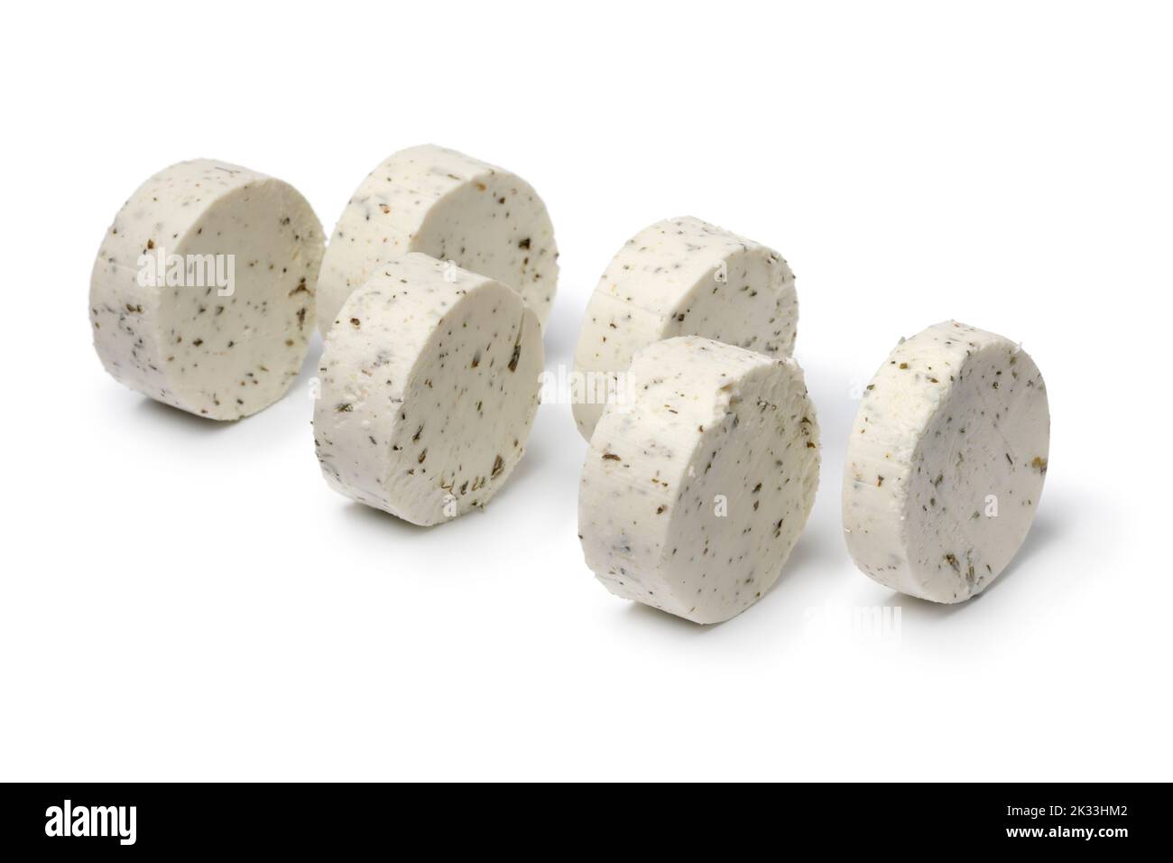 Slices soft Dutch goat cheese with herbs close up isolated on white background Stock Photo