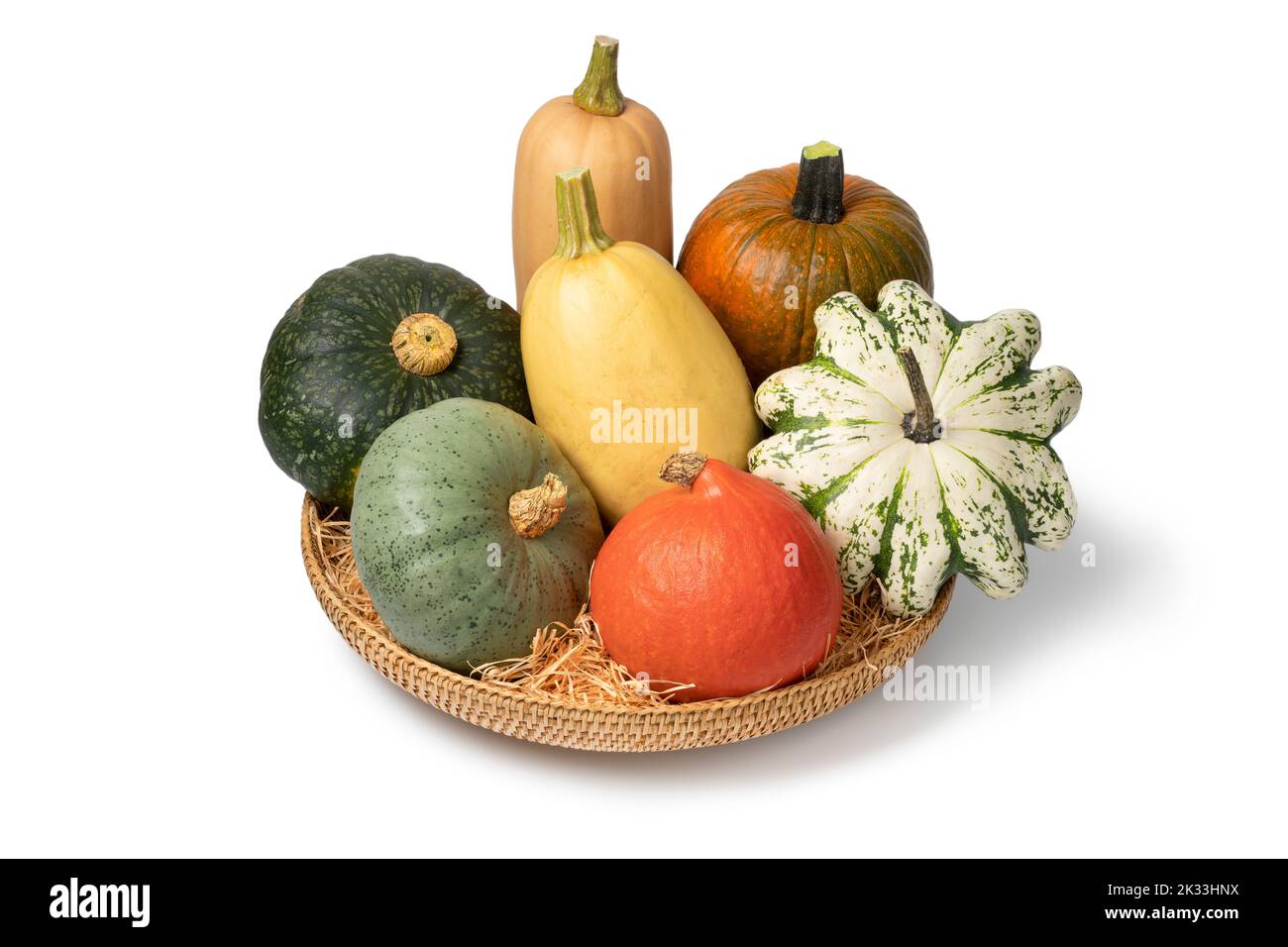 Basket with a variation of autumn pumpkins isolated on white background Stock Photo