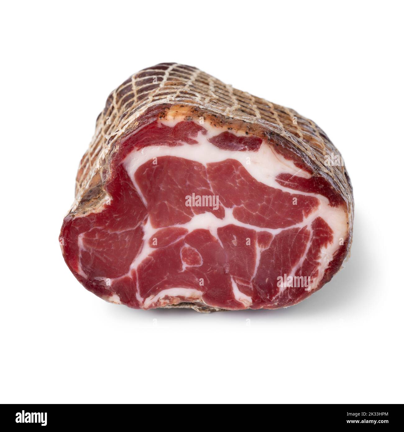 Piece of traditional Croatian dried pork neck, pork collar bacon, close up isolated on white background Stock Photo