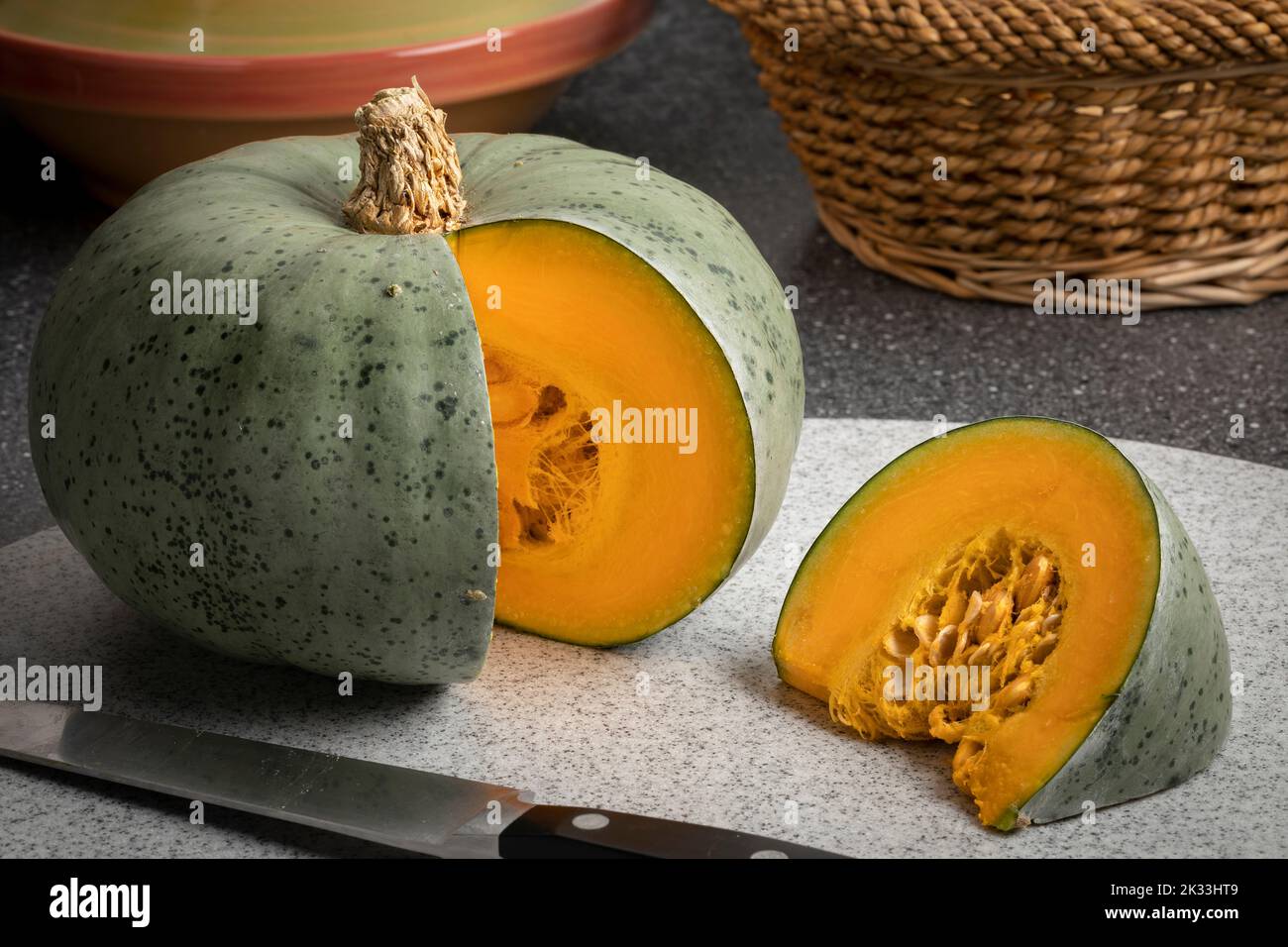 Fresh French Crown prince Pumpkin and a slice close up on a cutting board Stock Photo