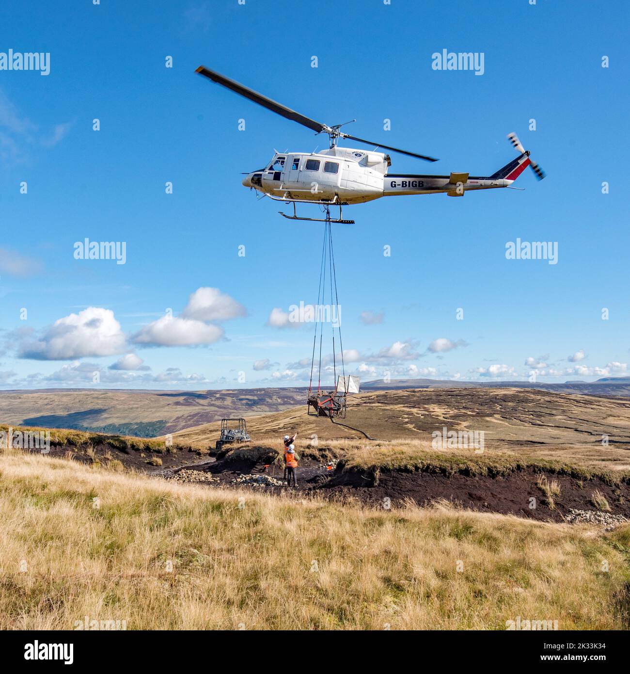 Heli-lift Services helicopter G-BIGB involved in peatland restoration work  at Fountains Fell in the Yorkshire Dales National Park 23rd September 2022 Stock Photo