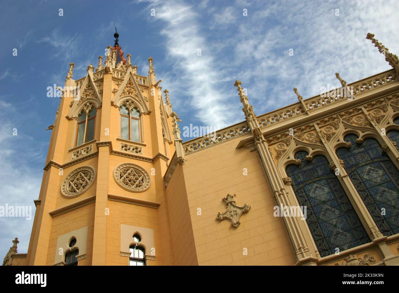 A gorgeous low angle shot of the Exposition Palace in Valencia, Spain with an elaborate design on its orange walls and dark blue windows Stock Photo