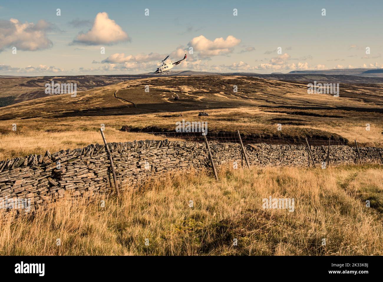 Heli-lift Services helicopter G-BIGB involved in peatland restoration work  at Fountains Fell in the Yorkshire Dales National Park 23rd September 2022 Stock Photo