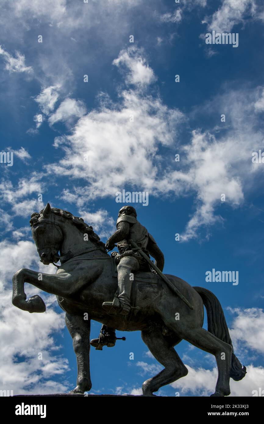A low-angle shot of the Equestrian Statue of Simon Bolivar against a blue cloudy sky Stock Photo