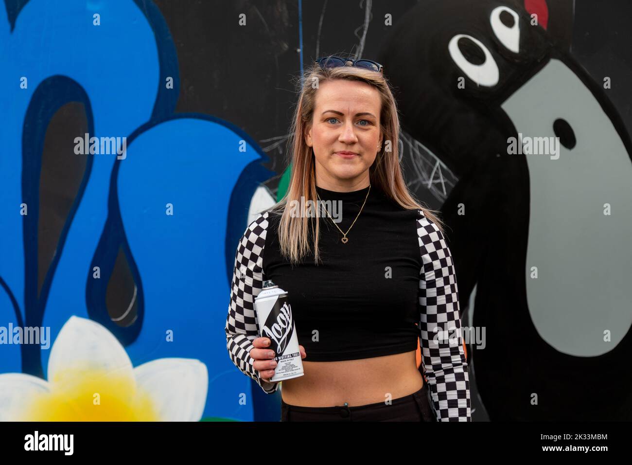 Birmingham, UK. 24th Sep, 2022. 'Rezy', one of about a dozen women street graffiti artists working on walls in Digbeth as part of the High Vis Street Art Festival at the Tea Works. Street art of this kind is often seen as a male dominated culture, but this is changing. Credit: Peter Lopeman/Alamy Live News Stock Photo