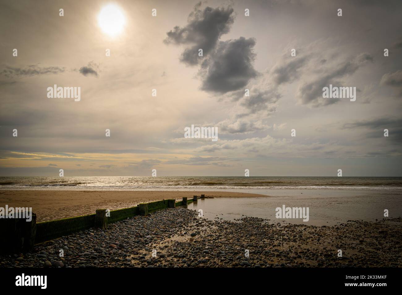 An autumnal HDR seacape image of Fleetwood beach with calm seas, hazy sun and solitude, Lancashire, England. 05 September 2022 Stock Photo