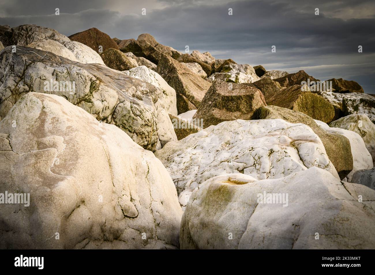 An autumnal HDR image of boulders piled up to form a sea defence structure at Fleetwood, lancashire, England. 05 September 2022 Stock Photo