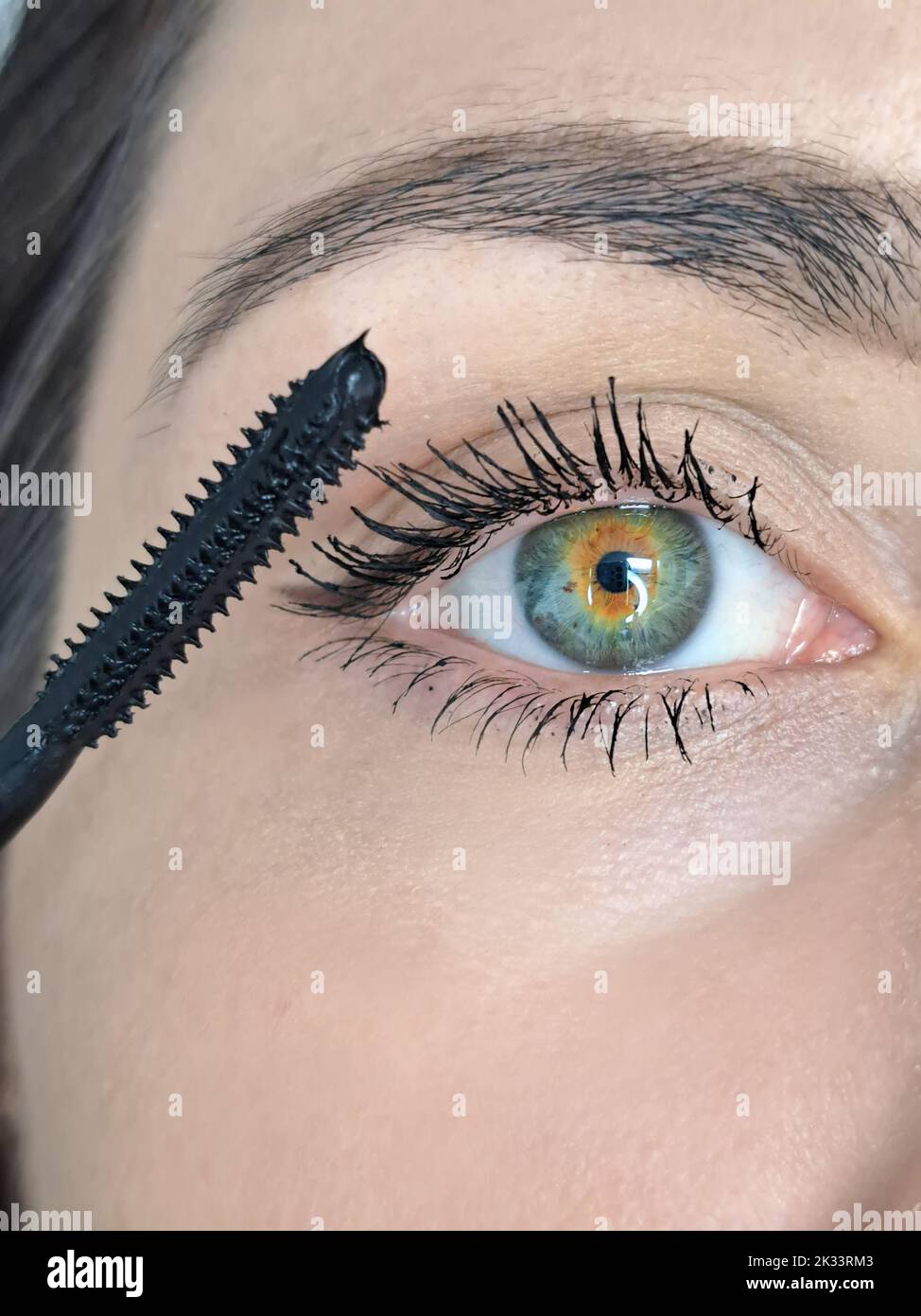 Close up of woman's eye mascara against lash extensions  Stock Photo
