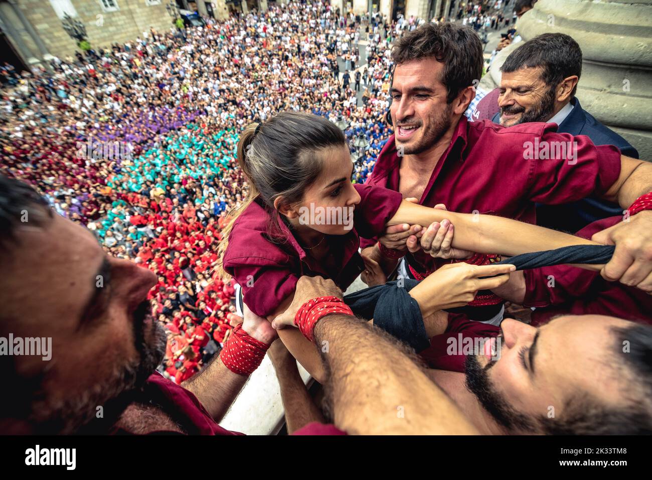 Barcelona, Spain. 24th Sep, 2022. 'Castellers de Sarria' pull up a member of their 'colla' from the ground to the town hall's balcony during the 'Diada Castellera' at Barcelona's city festival 'La Merce' Credit: Matthias Oesterle/Alamy Live News Stock Photo