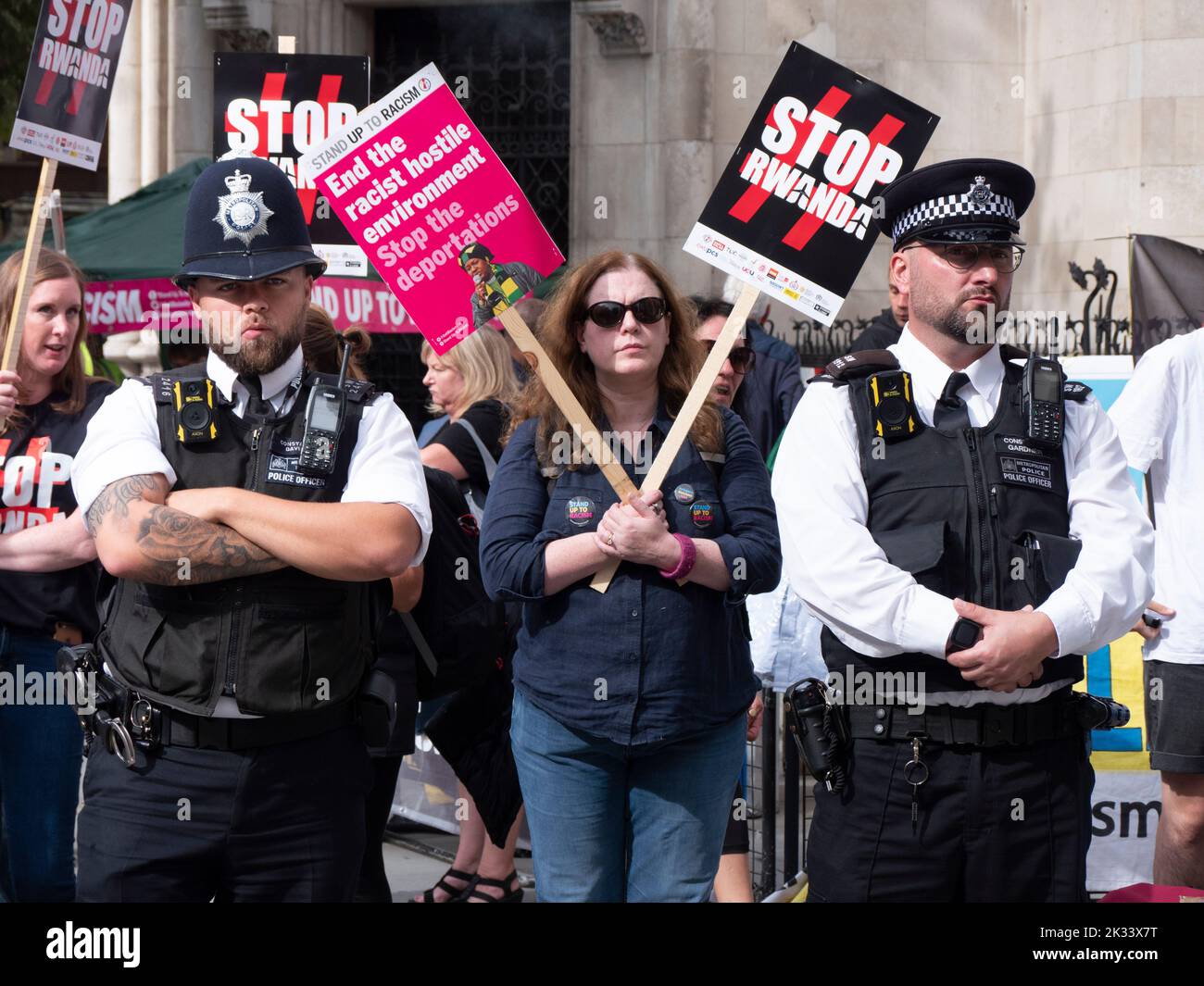 Police officers with Protestors and demonstrators outside the Royal Court of  Justice, during legal challenge to Government Rwanda deportation policy, brought by Care4Calais, Detention Action, Public and Commercial Services Union and asylum seekers facing deportation Stock Photo