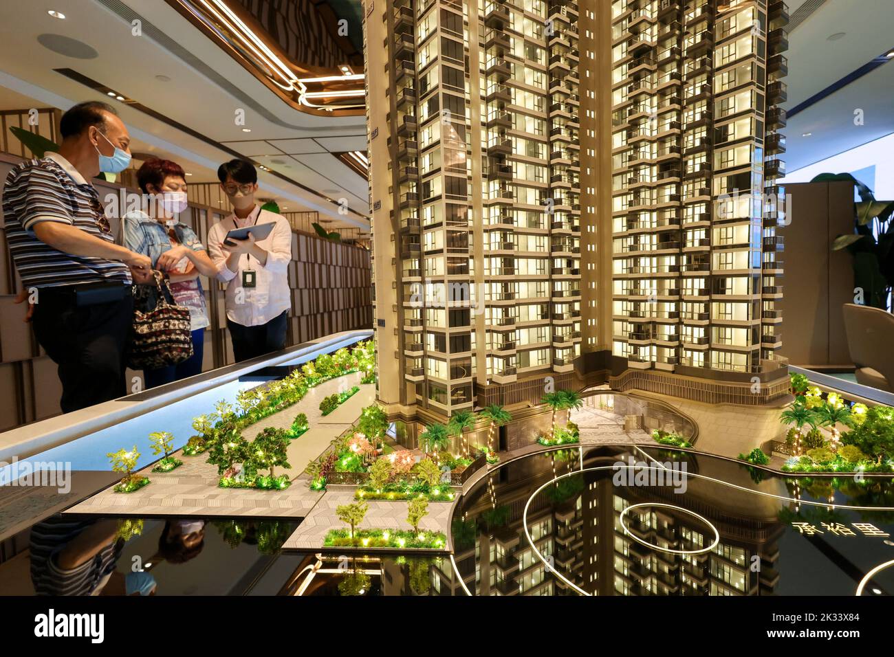 Potential buyers look at a model of Miami Quay, a residential project