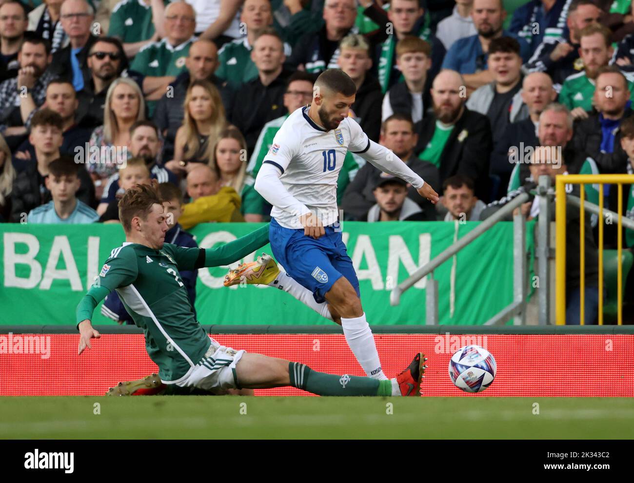 Northern Ireland's Conor Bradley (left) and Kosovo's Elbasan Rashani battle for the ball during the UEFA Nations League Group J Match at Windsor Park, Belfast. Picture date: Saturday September 24, 2022. Stock Photo