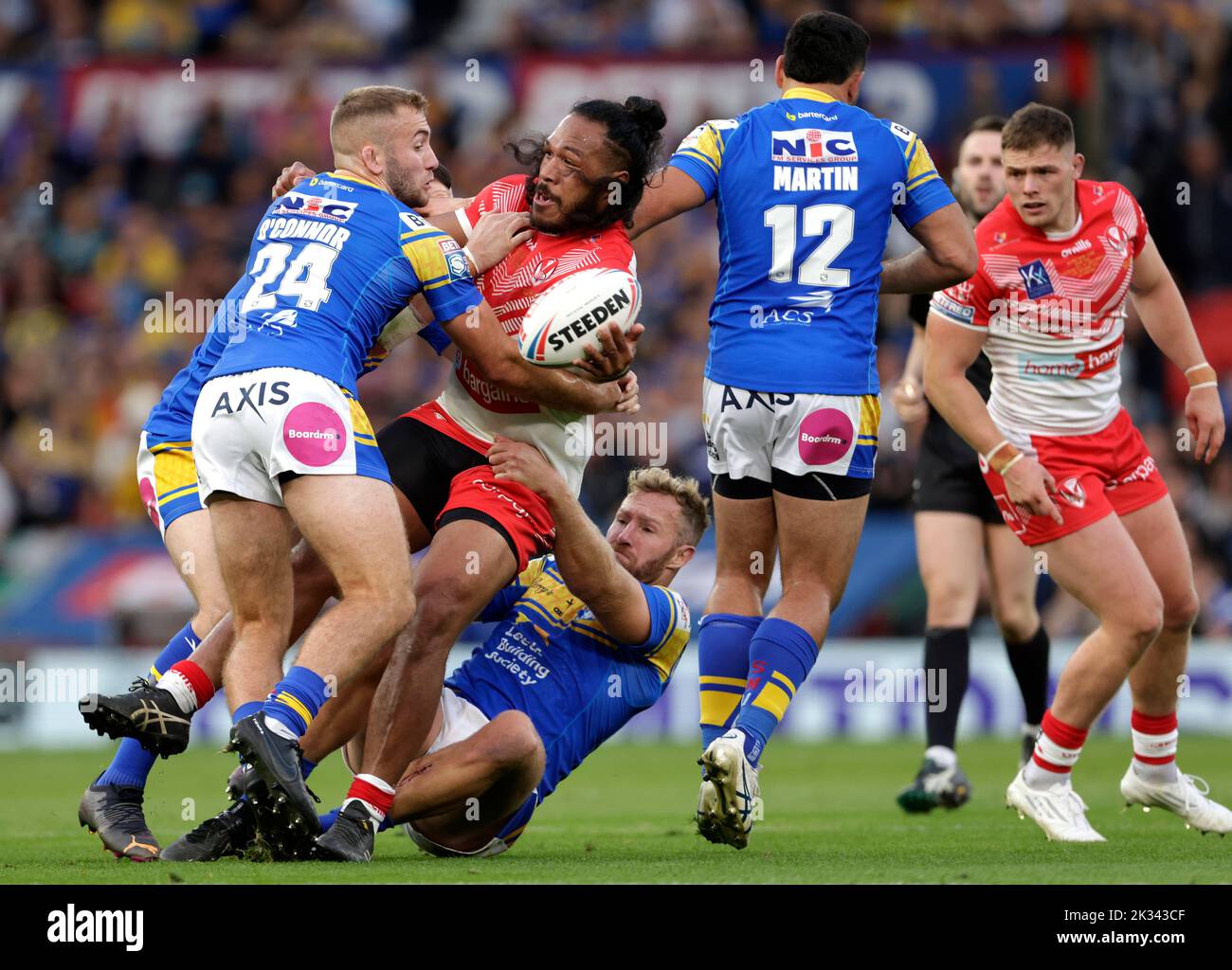 St Helens' Agnatius Paasi is tackled by Leeds Rhinos' Jarrod O'Connor (left) during the Betfred Super League Grand Final at Old Trafford, Manchester. Picture date: Saturday September 24, 2022. Stock Photo