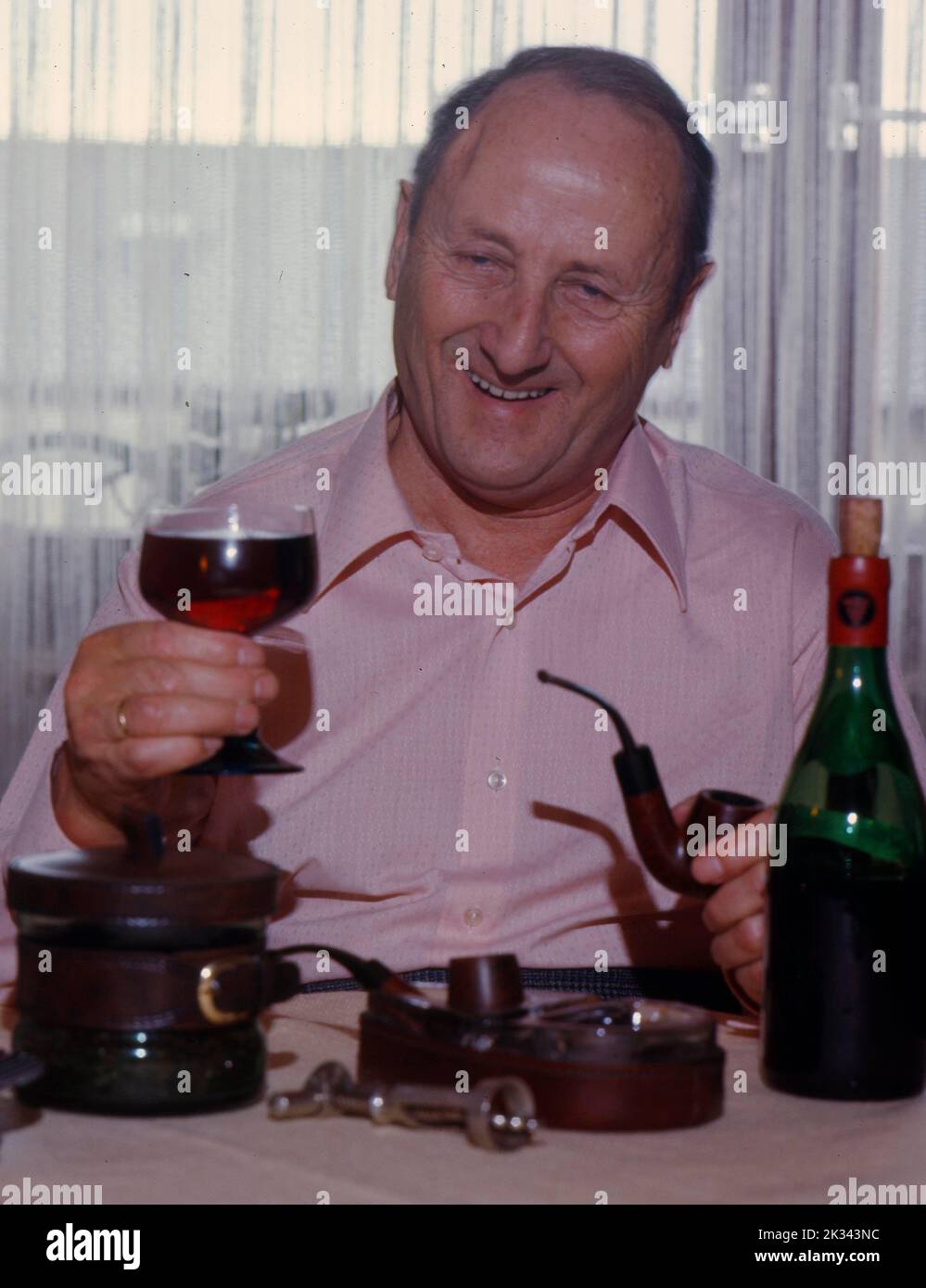 Elderly man drinking red wine Stock Photo