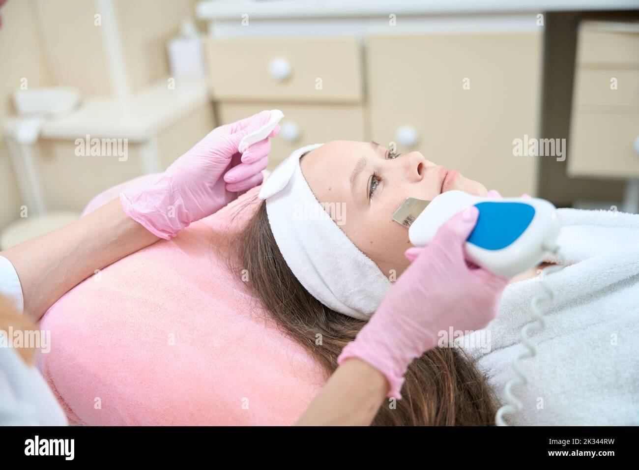 Profile of face of girl during ultrasonic cleaning with scrubber Stock Photo