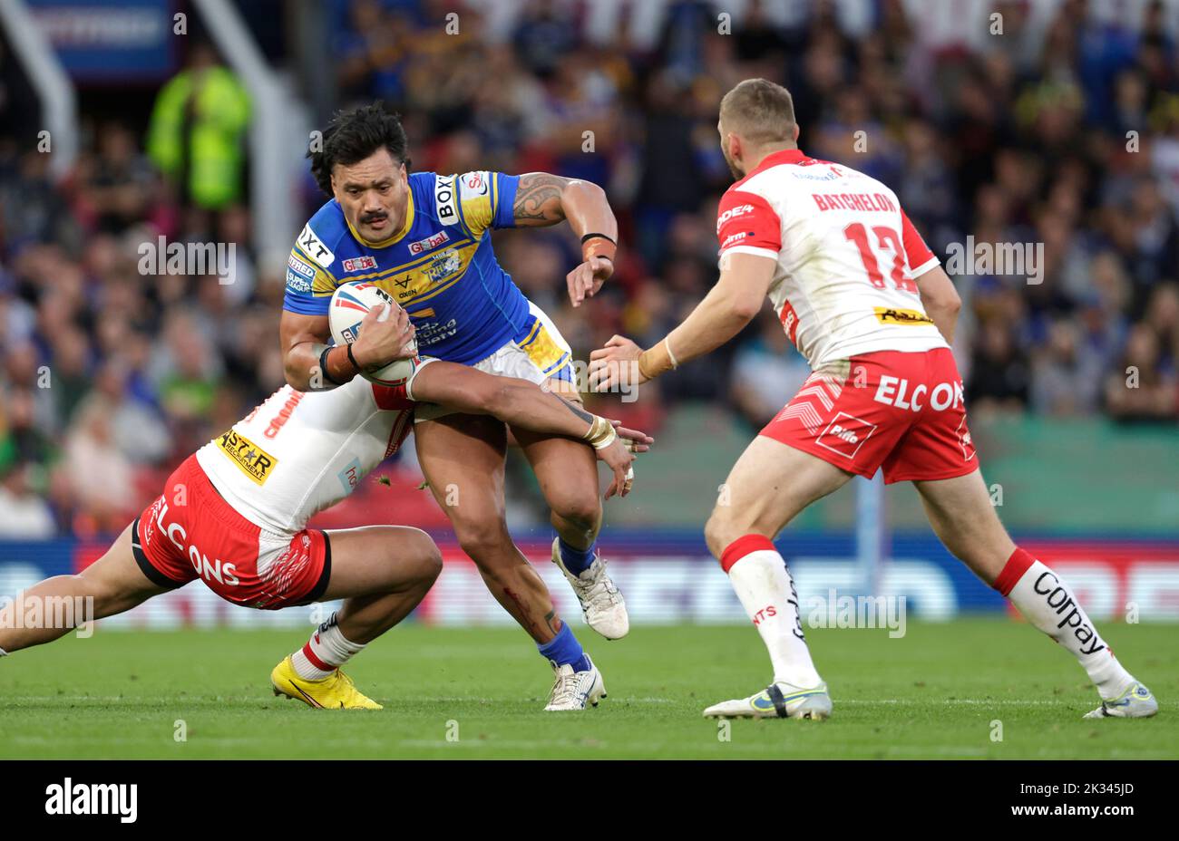 Leeds Rhinos' Zane Tetevano (center) is tackled by St Helens' Sione Mata’utia (left) and Joe Batchelor during the Betfred Super League Grand Final at Old Trafford, Manchester. Picture date: Saturday September 24, 2022. Stock Photo