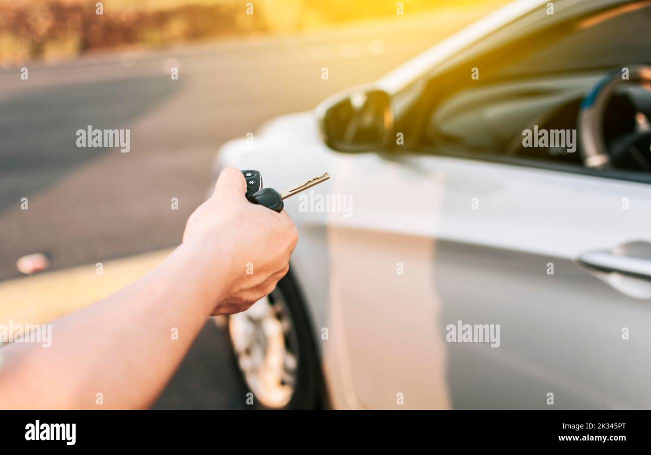 Closeup of driver outside car holding keys. Driver hands showing the