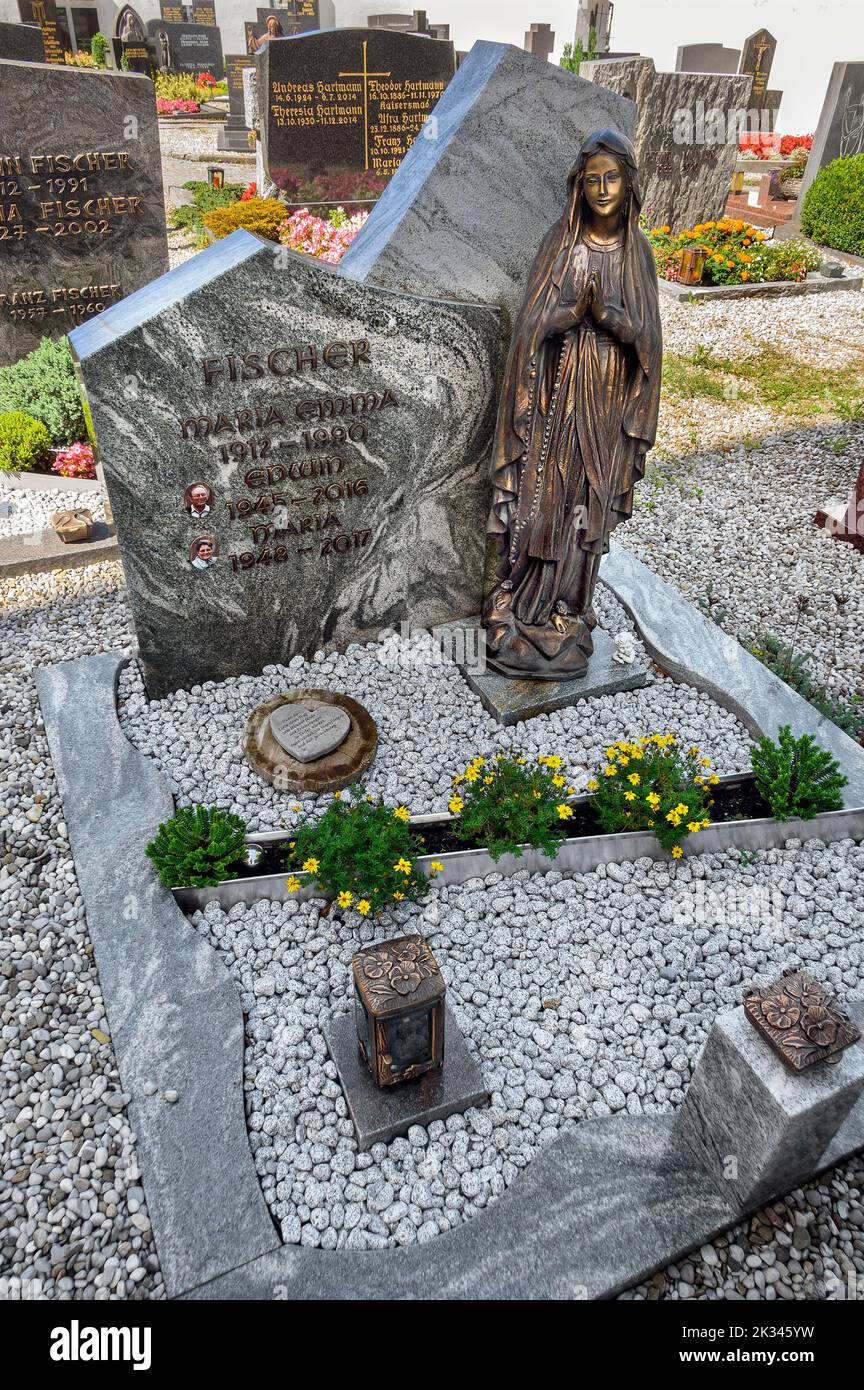 Grave with figure of the Virgin Mary in Betzigau, Allgaeu, Bavaria, Germany Stock Photo