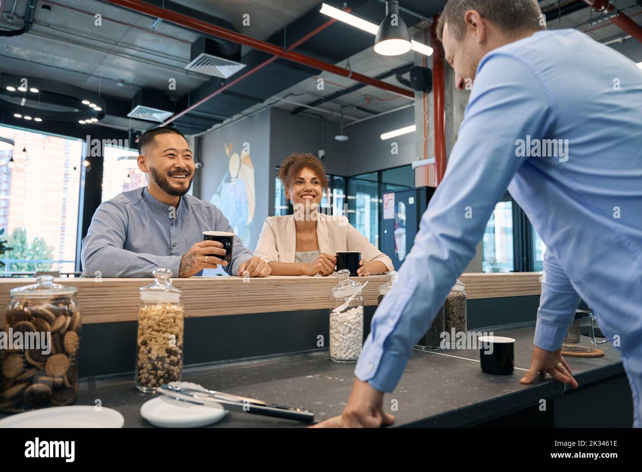 Three company employees enjoying their coffee break Stock Photo