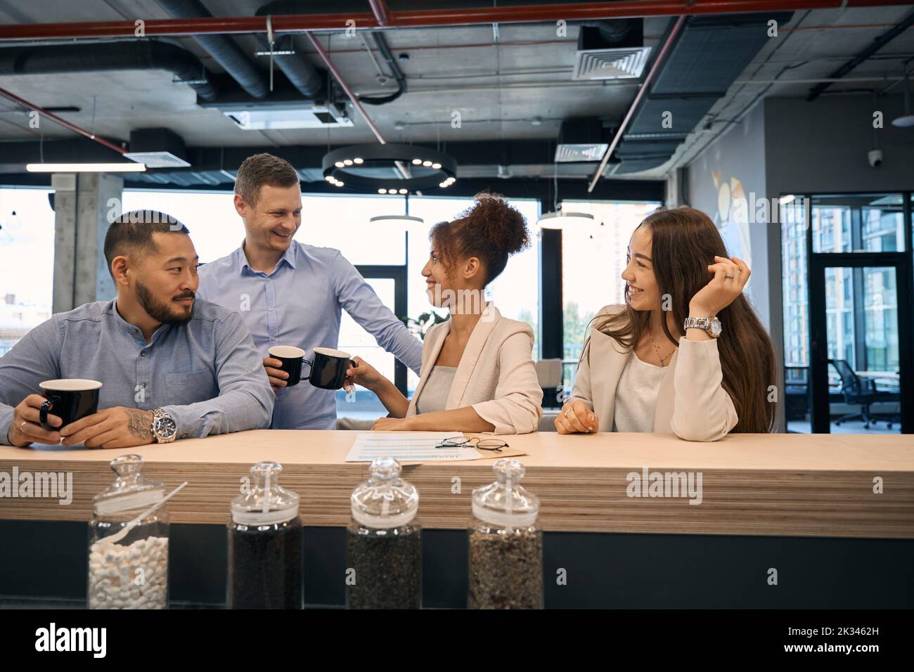 Young company employees enjoying their coffee break Stock Photo