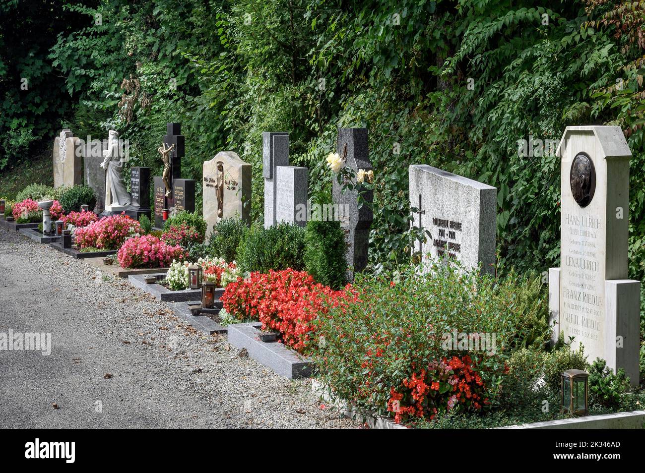Row of graves with floral decorations, Niedersonthofen, Allgaeu, Bavaria, Germany Stock Photo