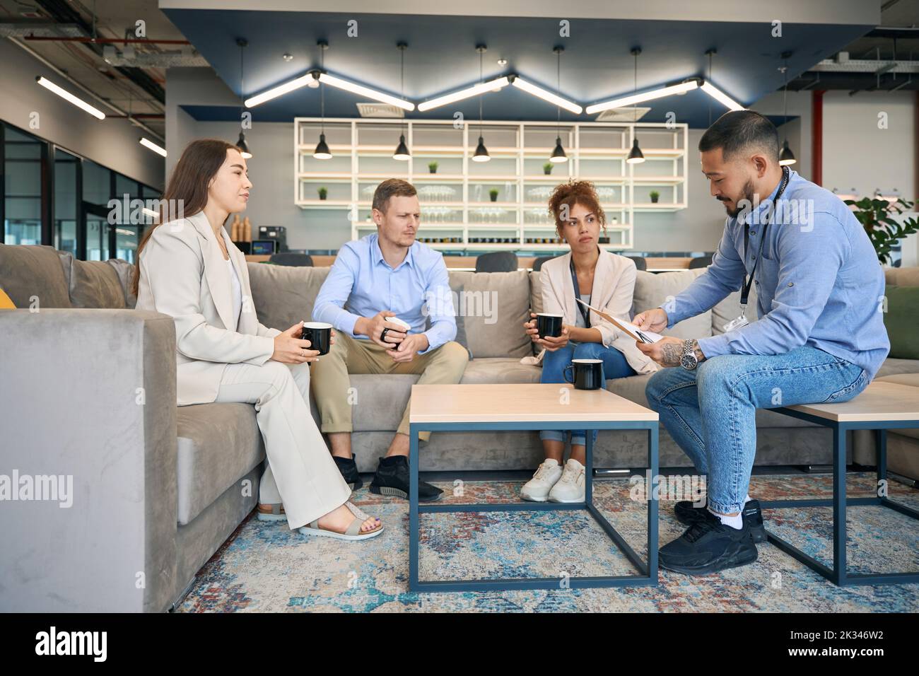 Young businesspeople working together in co-working space Stock Photo