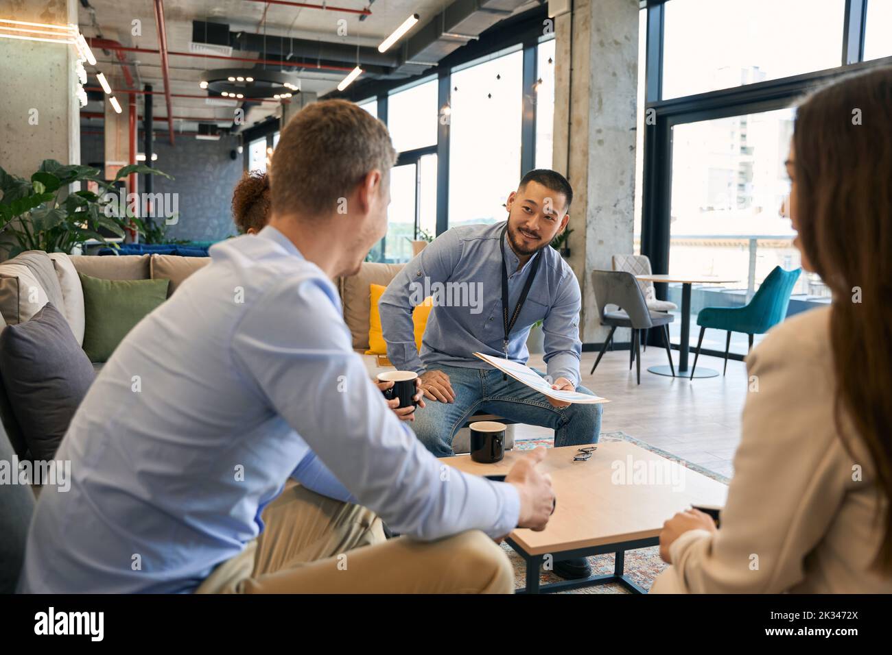 Entrepreneur conducting business meeting with his counterparts Stock Photo