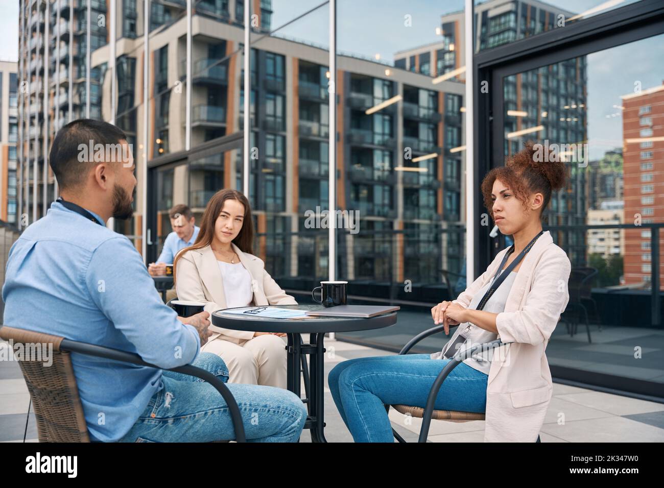 Group of businesspeople communicating during coffee break Stock Photo