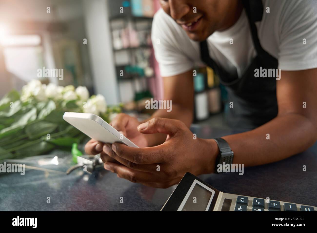 Flower shop employee in front of flowers Stock Photo