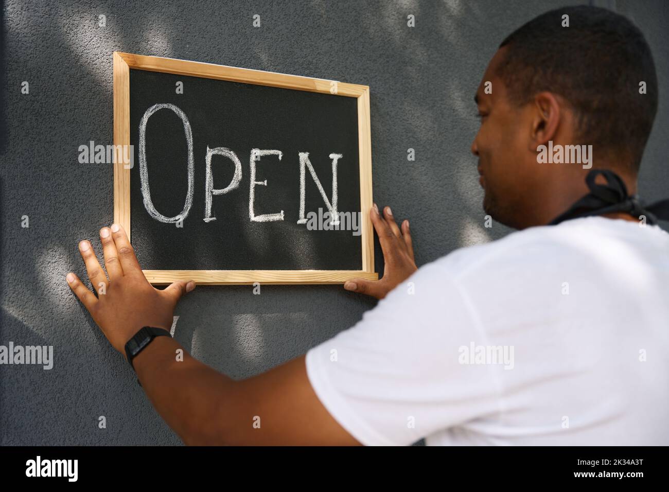 Plaque with the word open on the wall Stock Photo