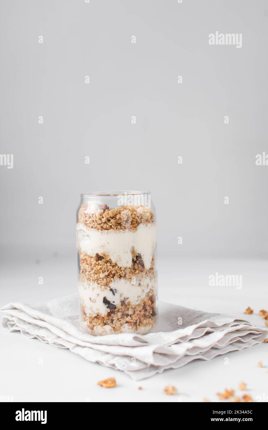 Granola and yogurt parfait in a can shaped glass, oats and nuts parfait