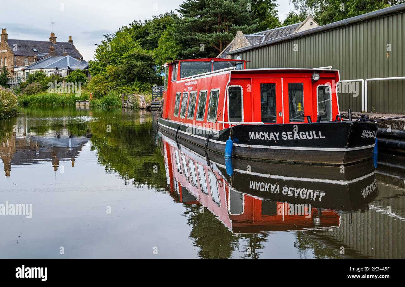 A narrow boat barge moored at Ratho on the Union Canal reflected in the water, Scotland, UK Stock Photo