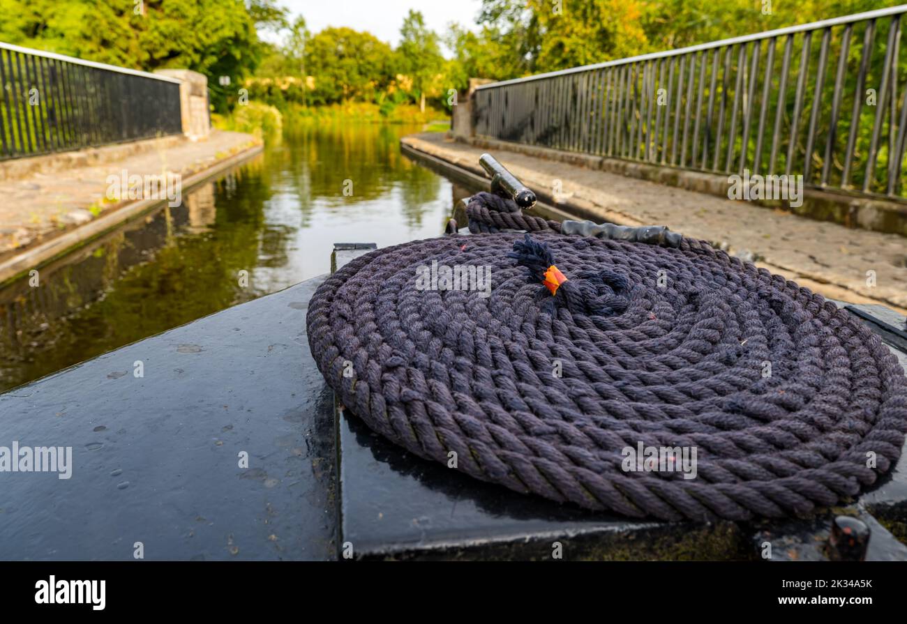 View from prow of a narrow boat barge with coiled rope on the Union Canal at Almond Aqueduct, Scotland, UK Stock Photo