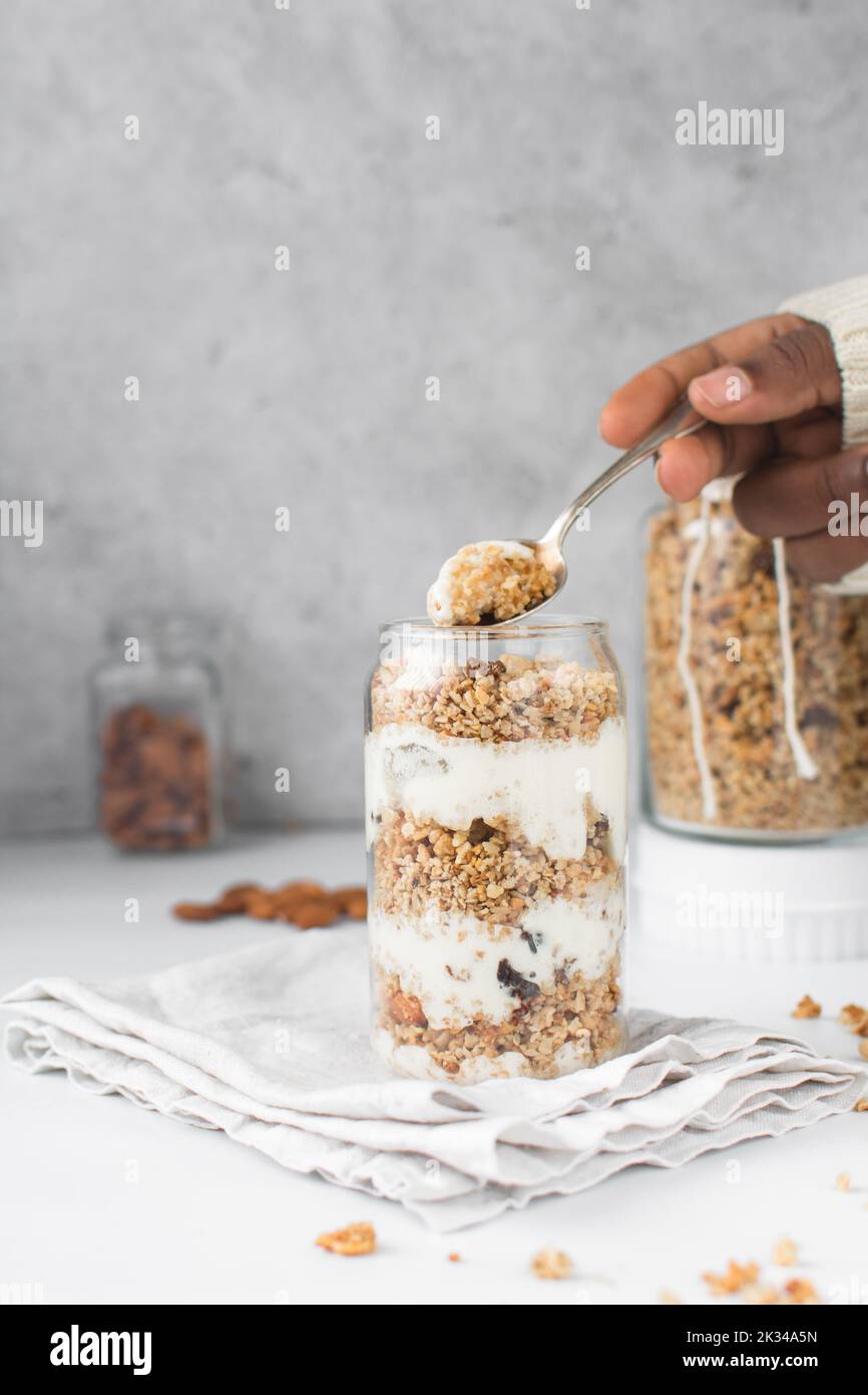 Granola and yogurt parfait in a can shaped glass, oats and nuts parfait