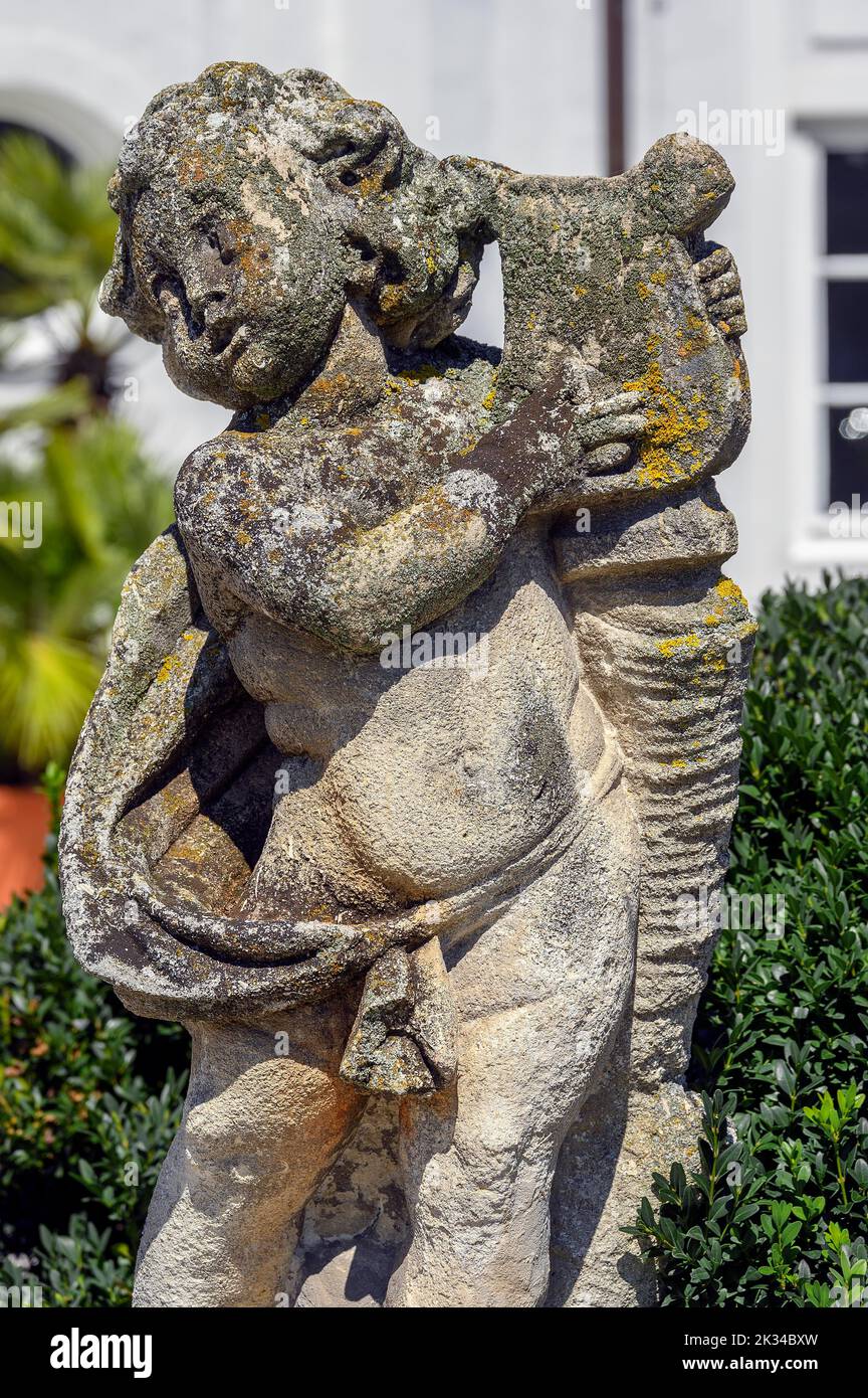 Weathered childlike stone figure in the Hofgarten, Kempten, Bavaria, Germany Stock Photo