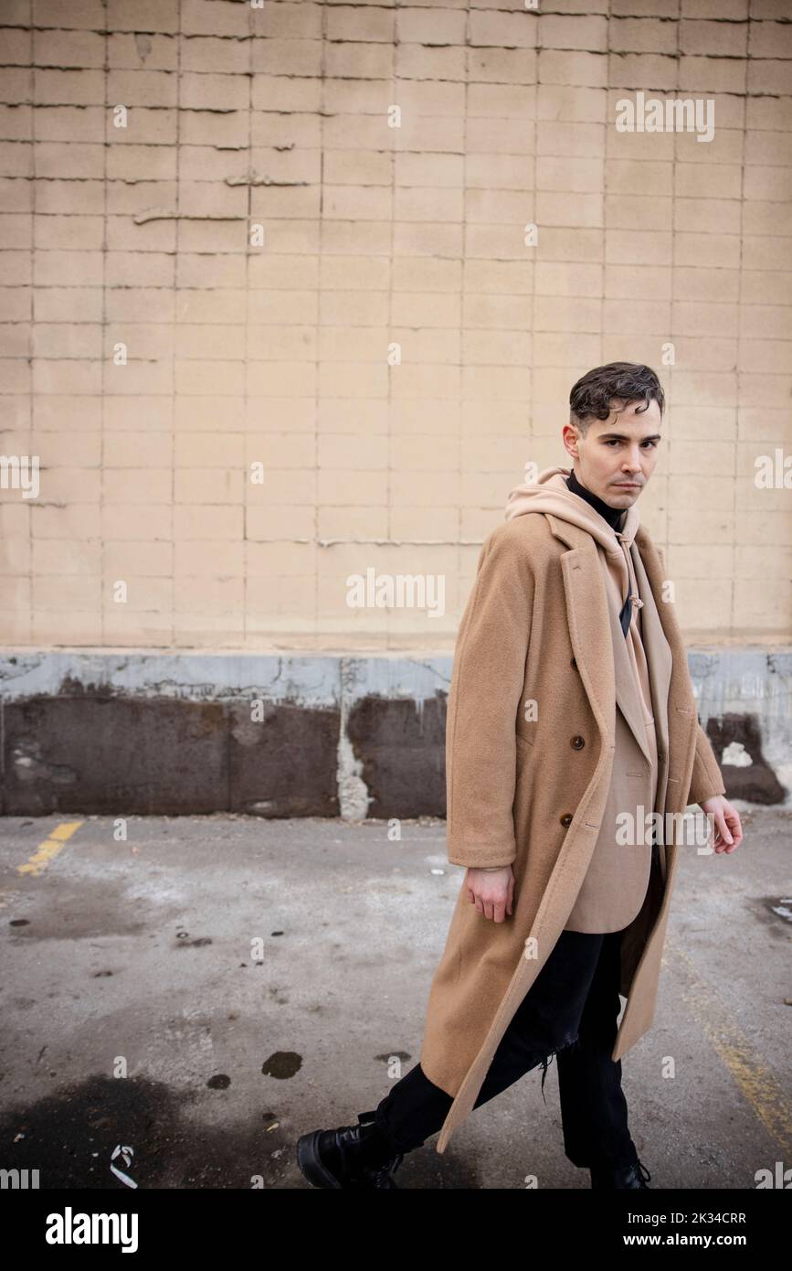 Man in coat walking side view hi-res stock photography and images - Alamy