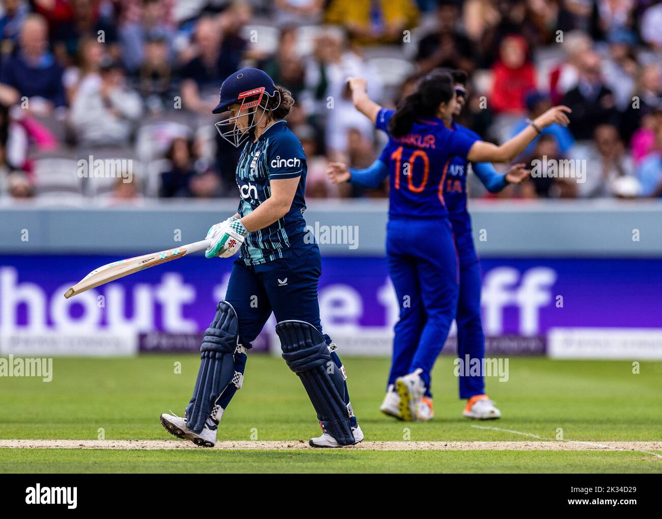 England's Tammy Beaumont walking of the field after bowled by India’s Renuka Thakur celebrates the wicket during the third women's one day international match at Lord's, London. Picture date: Saturday September 24, 2022. Stock Photo