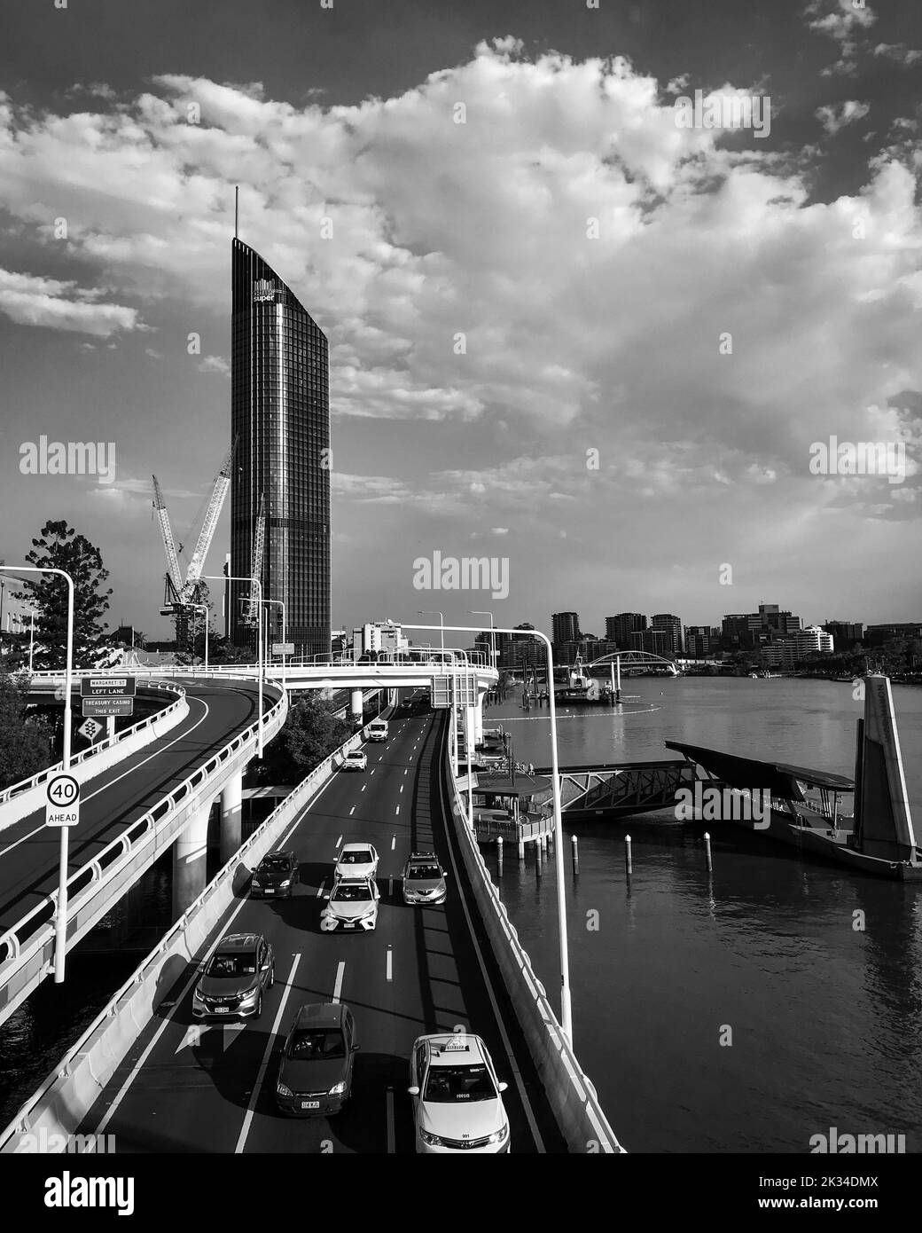 A vertical grayscale shot of a highway road and a modern building in ...