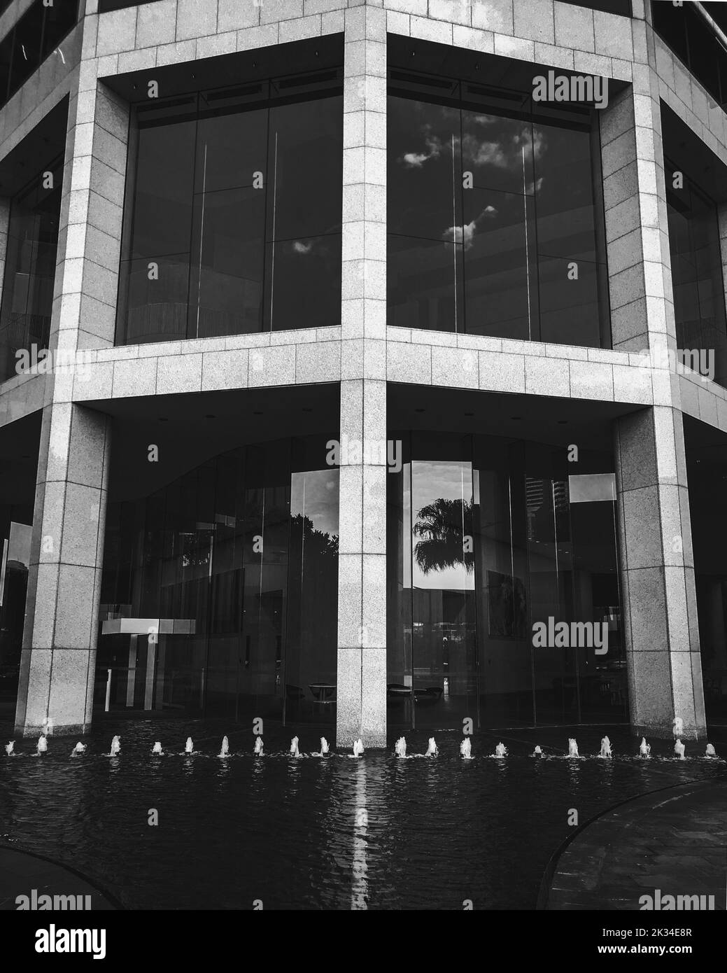 A vertical grayscale shot of a modern building facade in Brisbane, Australia Stock Photo