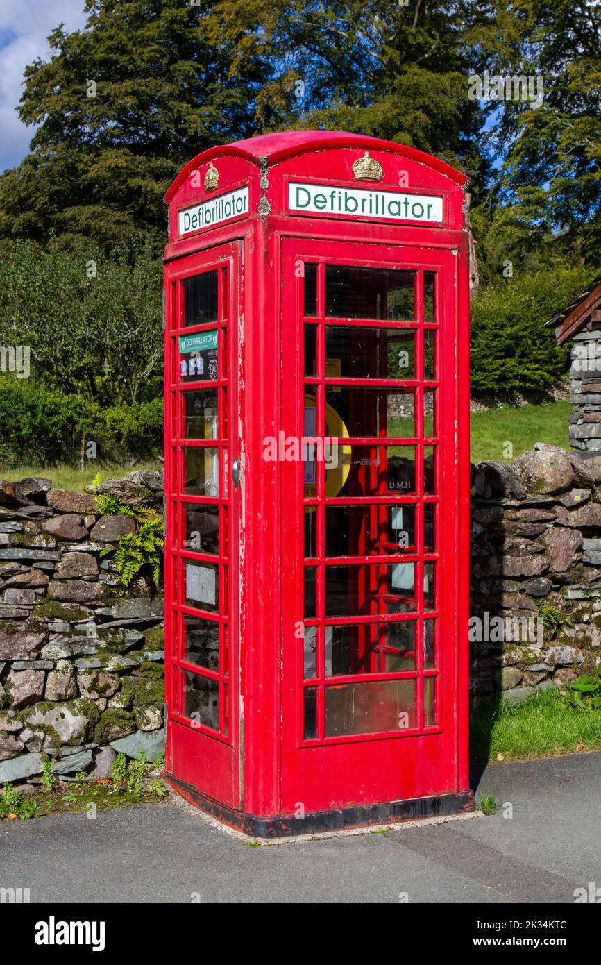 A red telephone box or being used to store a defibrillator to save people from a heart attack Stock Photo