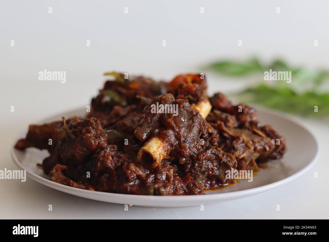 Mutton roast. Spicy mutton roast prepared in Kerala style. Shot on white background Stock Photo