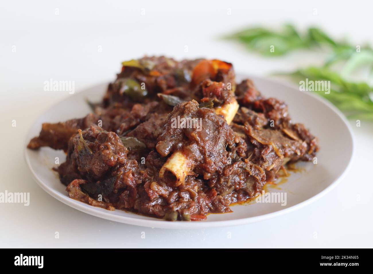 Mutton roast. Spicy mutton roast prepared in Kerala style. Shot on white background Stock Photo