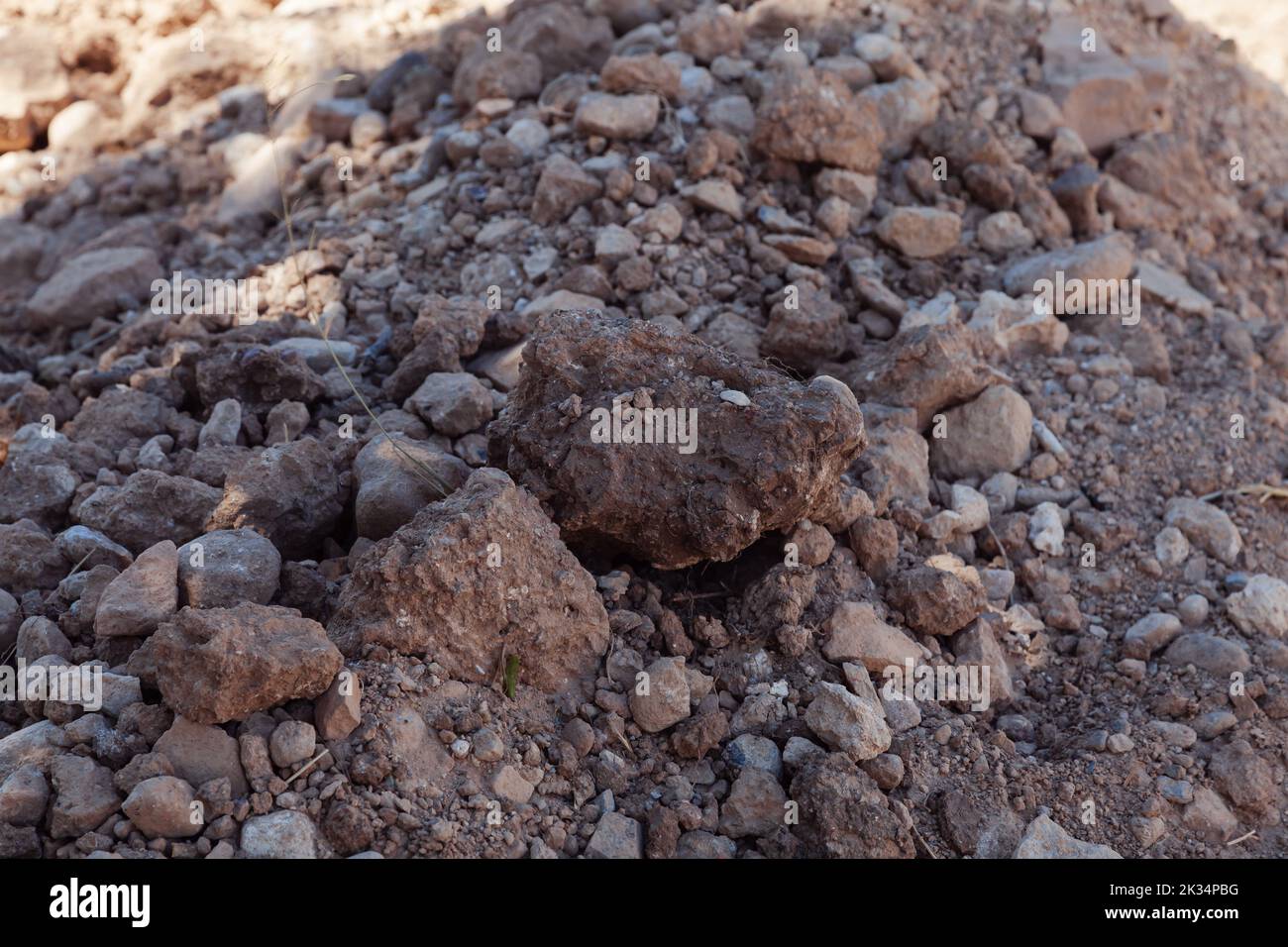 Close-up of stony soil. Ground texture stone and earth. Stock Photo