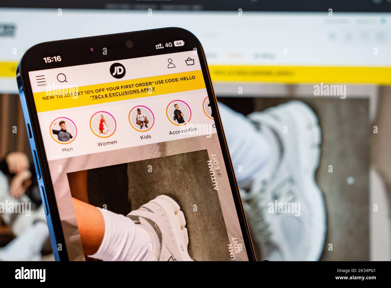 JD Sports Mobile Website with laptop website in the background Stock Photo