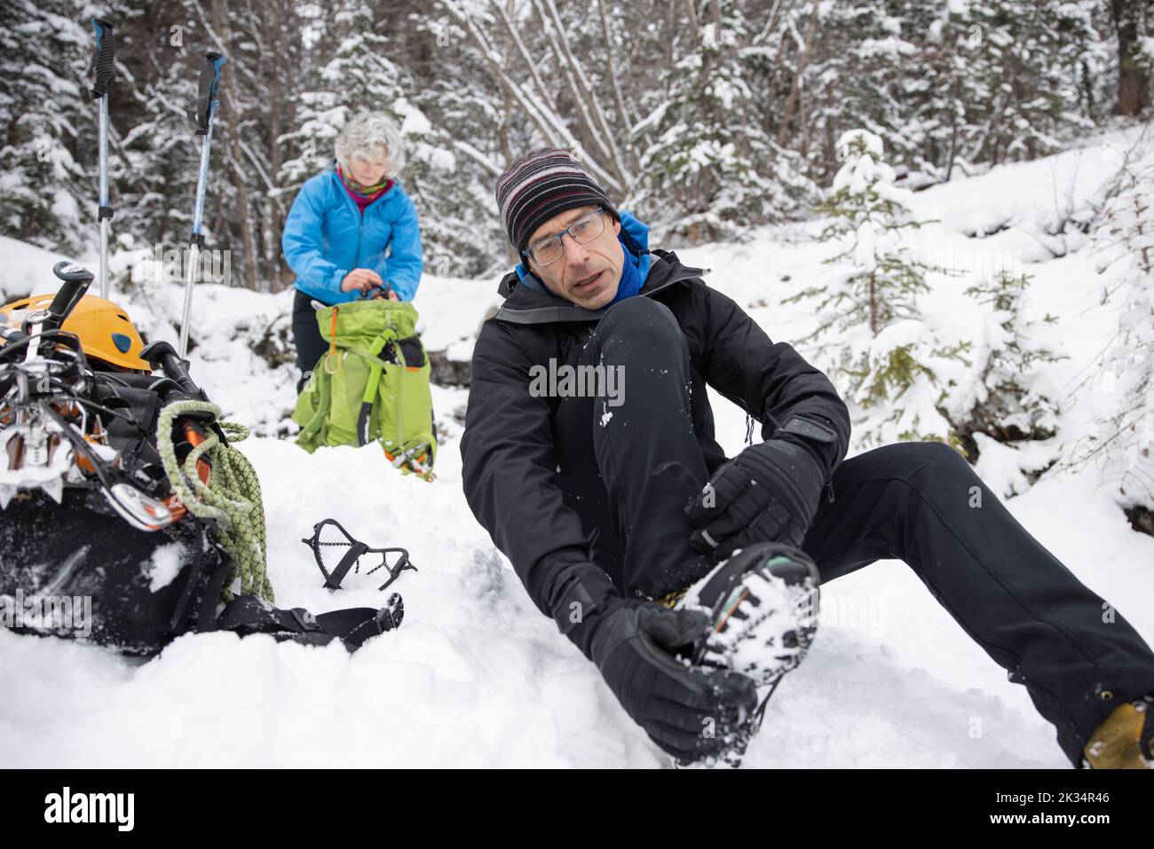 Ice climber putting on ice cleats on shoe Stock Photo Alamy