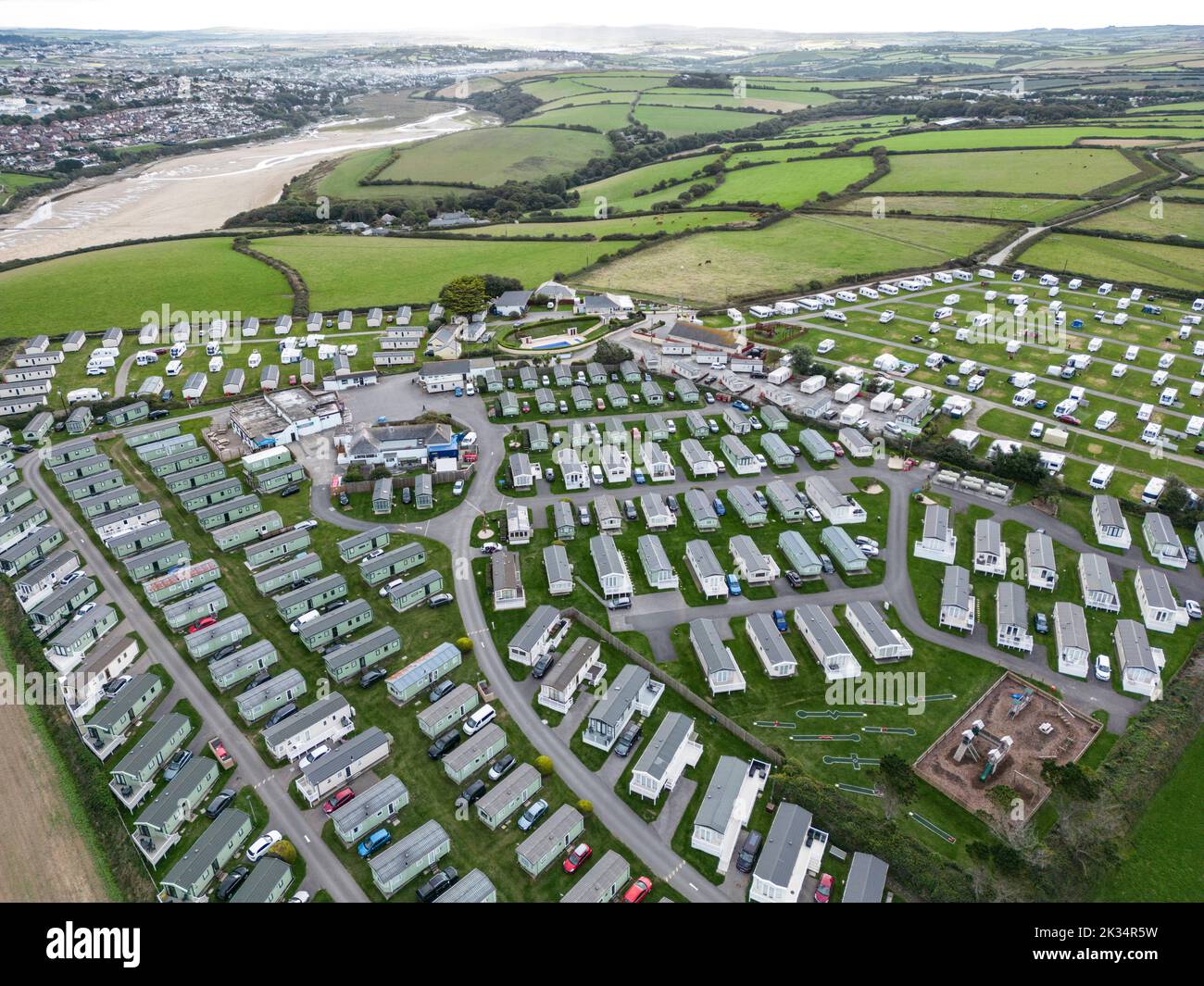 A static Caravan park with its lines of caravans on the north Cornwall coast at Crantock, ENgland.  Caravans are popular holiday accommodation. Stock Photo