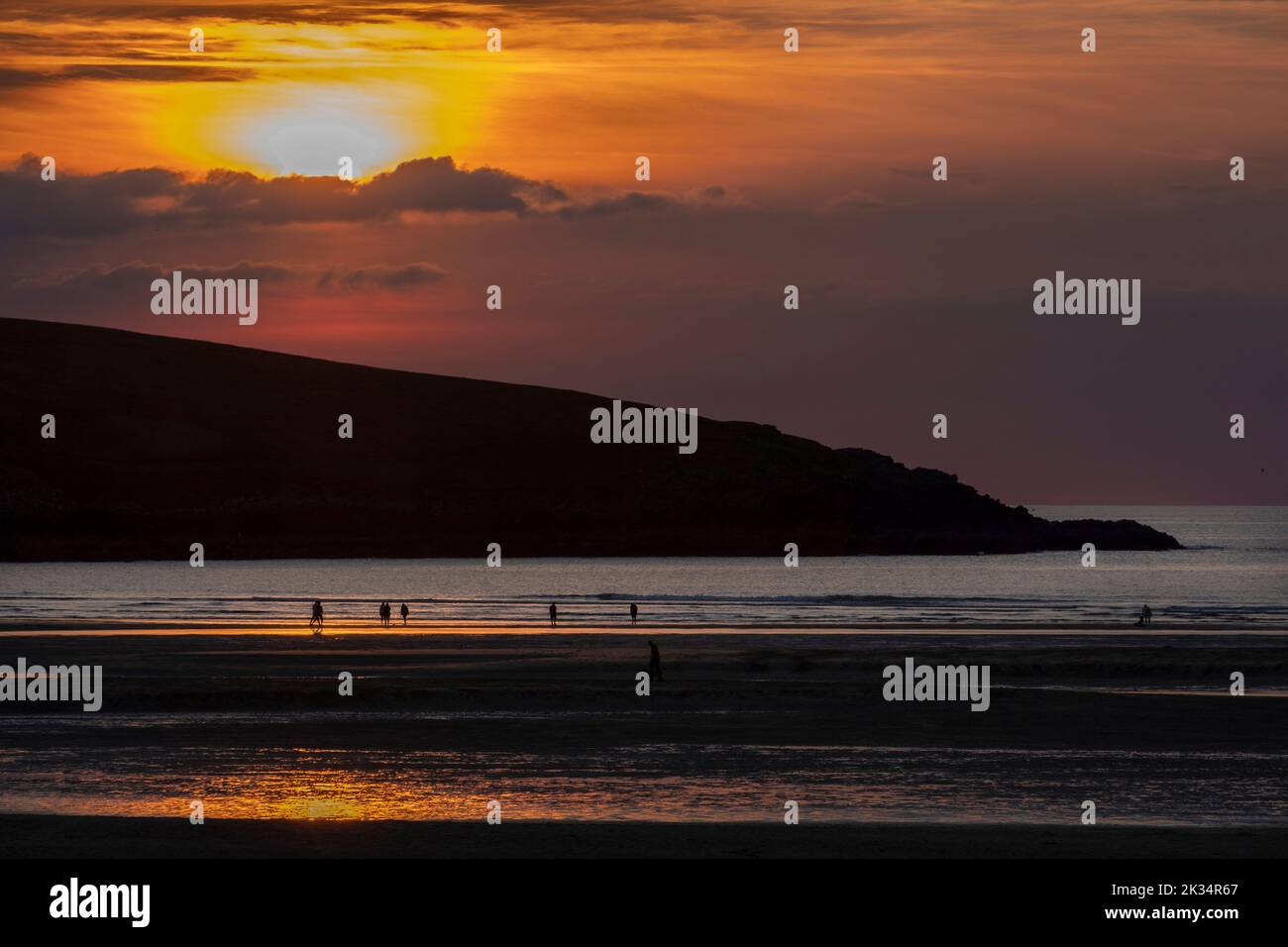 Sunset on Crantock beach in North Cornwall looking out to the Atlantic Ocean. Stock Photo