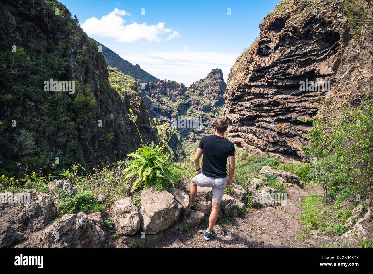 A Caucasian male enjoying his vacation in a rocky landscape with majestic sceneries Stock Photo