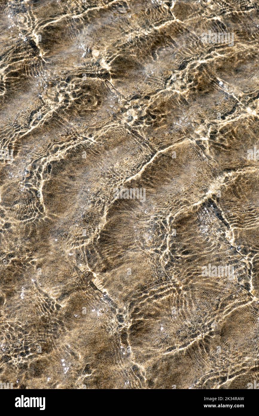Ripples in the ocean at low tide creating patterns in the sand, Cornwall, England. Stock Photo
